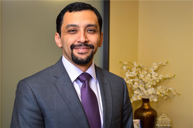 Murillo Plastic Surgery founder Dr. Carlos Murillo in a gray suit